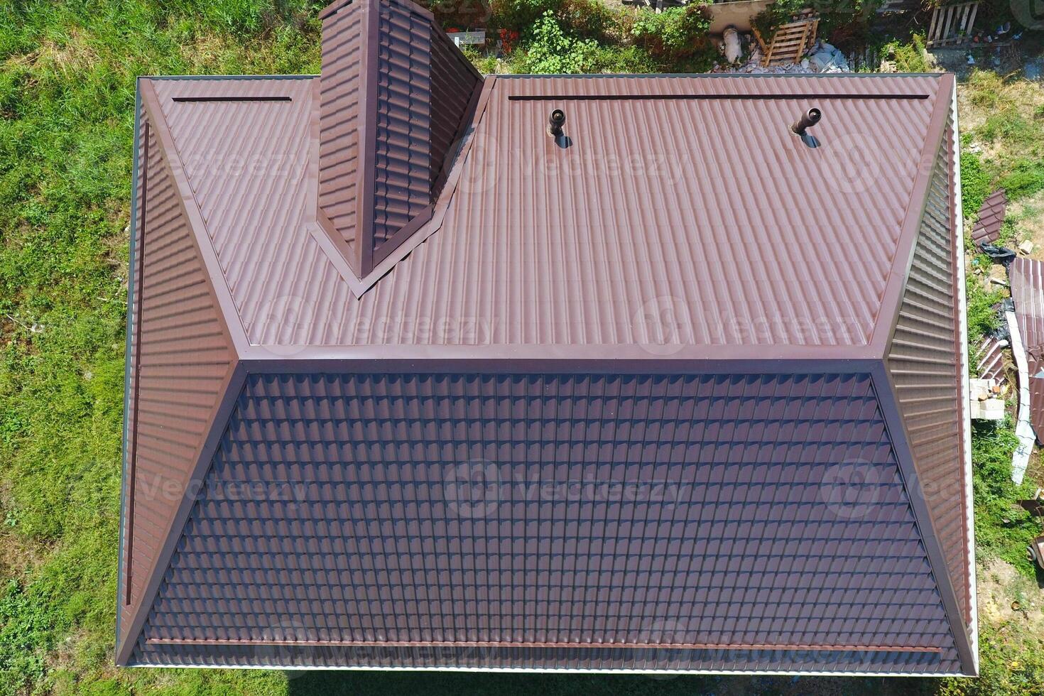 A view from above on the roof of the house. The roof of corrugated sheet. Roofing of metal profile wavy shape photo