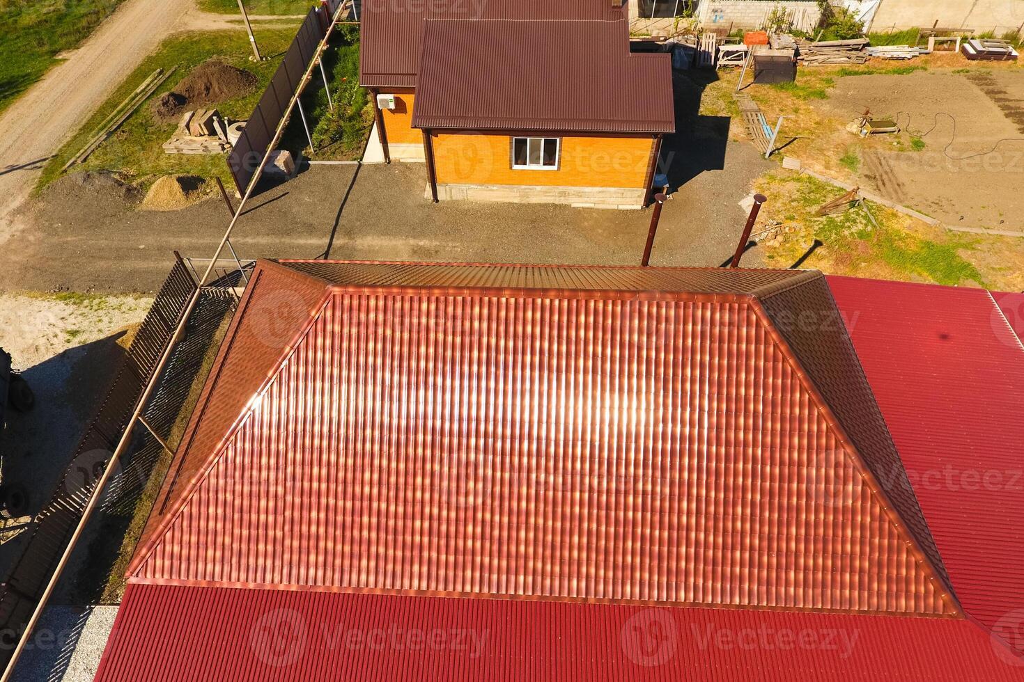 A house with a canopy over the courtyard. Roof from corrugated metal profile. Metal tiles. photo