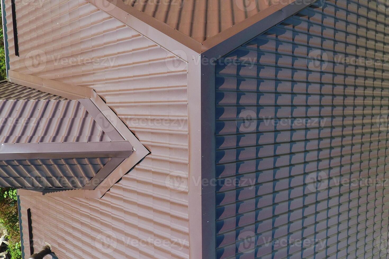 A view from above on the roof of the house. The roof of corrugated sheet. Roofing of metal profile wavy shape photo