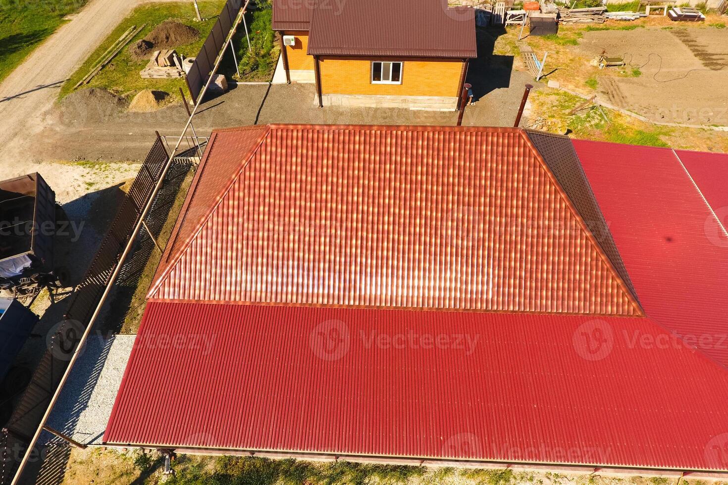 A house with a canopy over the courtyard. Roof from corrugated metal profile. Metal tiles. photo