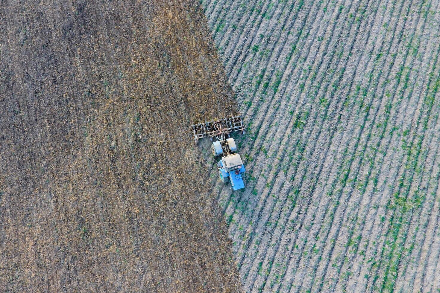 Top view of the tractor that plows the field. disking the soil. Soil cultivation after harvest photo