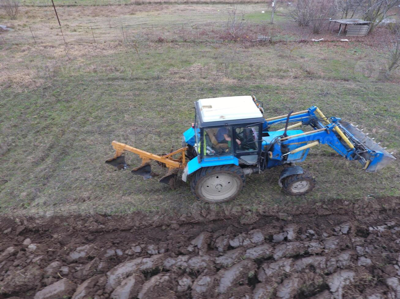 Tractor plowing the garden. Plowing the soil in the garden photo