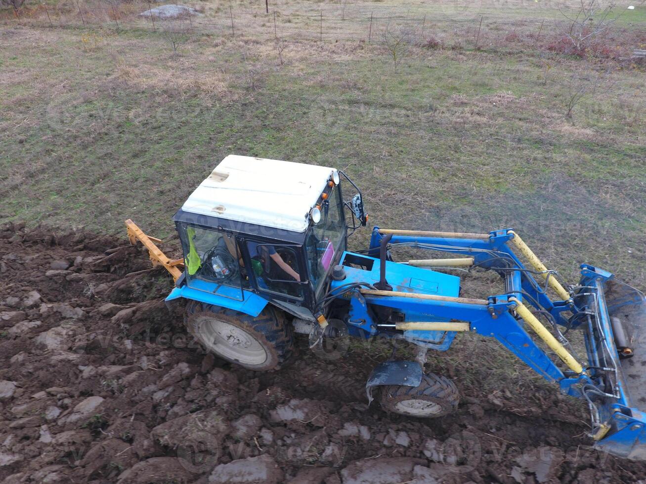Tractor plowing the garden. Plowing the soil in the garden photo