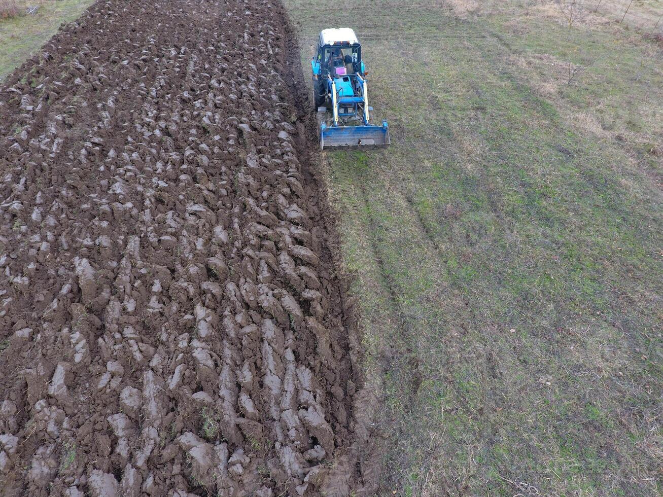 Tractor plowing the garden. Plowing the soil in the garden photo