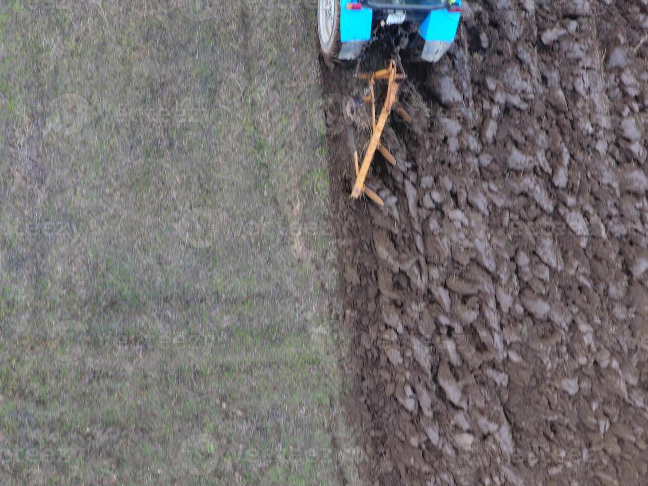 Tractor plowing the garden. Plowing the soil in the garden photo