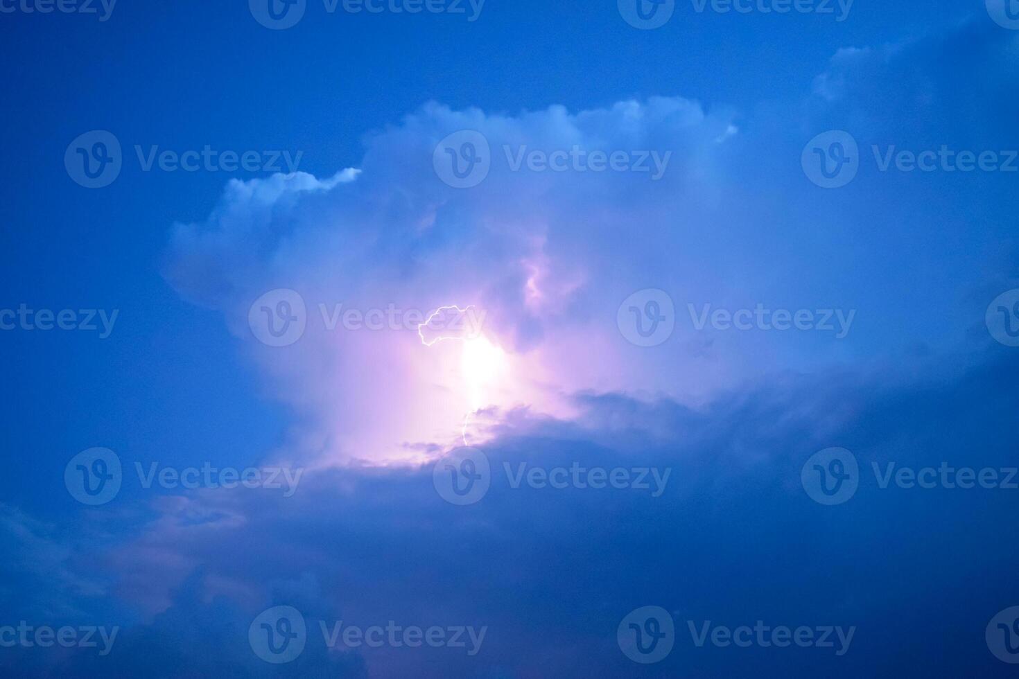 Lightnings in storm clouds. Peals of a thunder and the sparkling lightnings in clouds photo