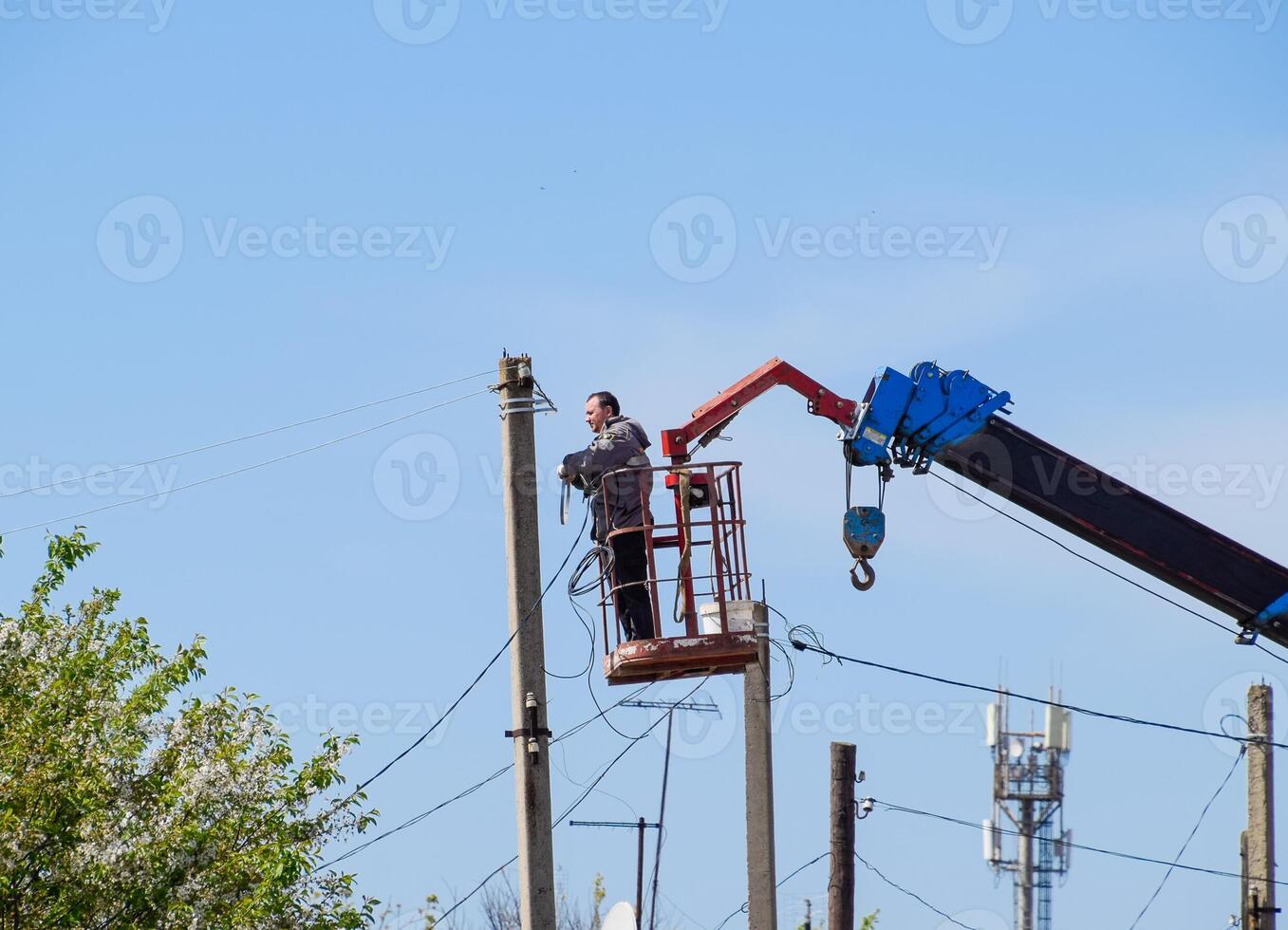 Electricians repair the power line. Workers are locksmith electricians. photo