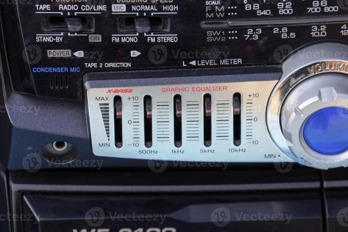 Cassette tape recorder with radio on a blue wooden table. Vintag photo