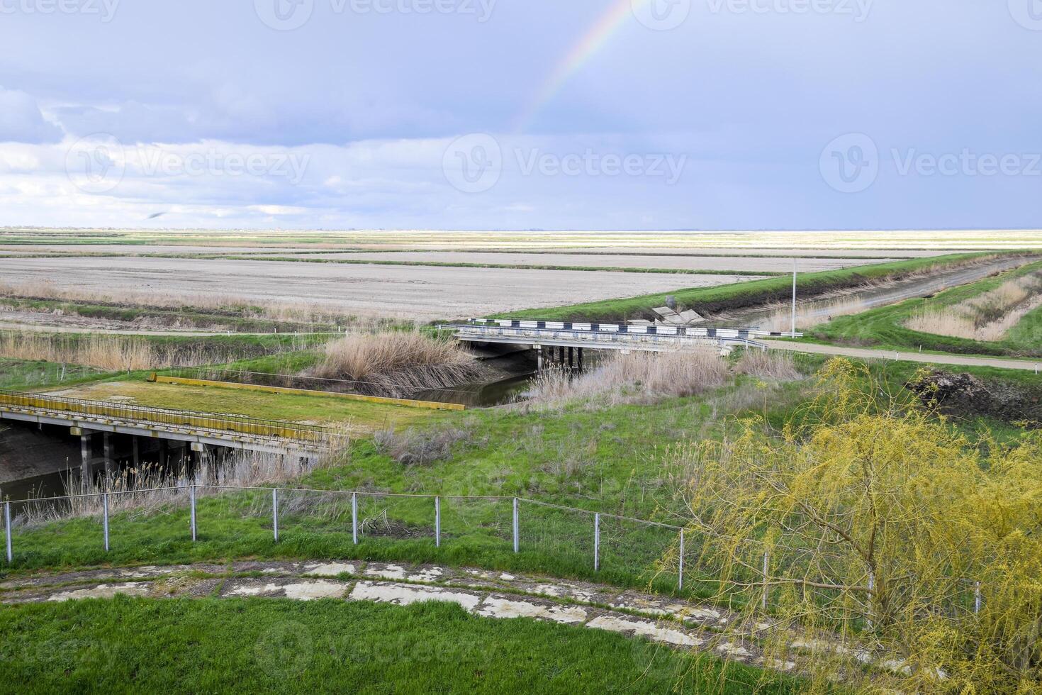 Bridges through irrigation canals. Rice field irrigation system photo