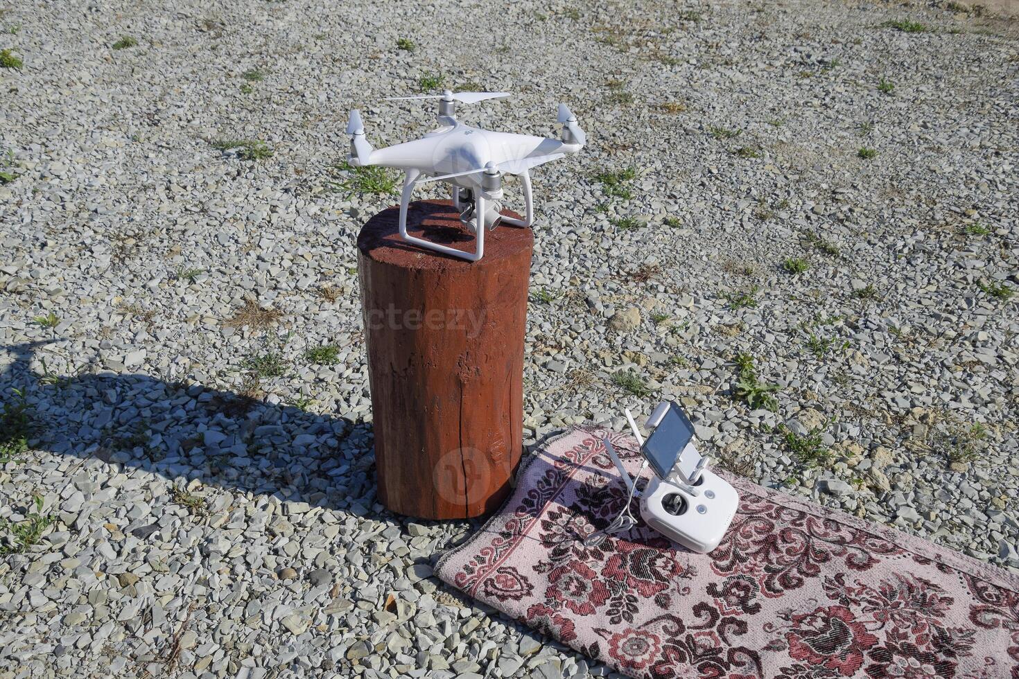 Quadrocopter DJI Phantom 4 on a wooden hemp. Preparing the drone for the flight. Dron is an innovative flying robot. photo