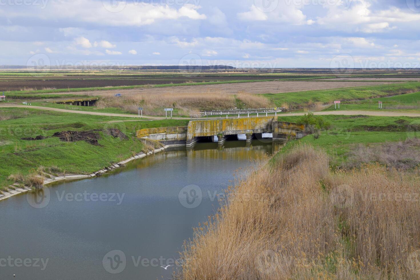 Bridges through irrigation canals. Rice field irrigation system photo