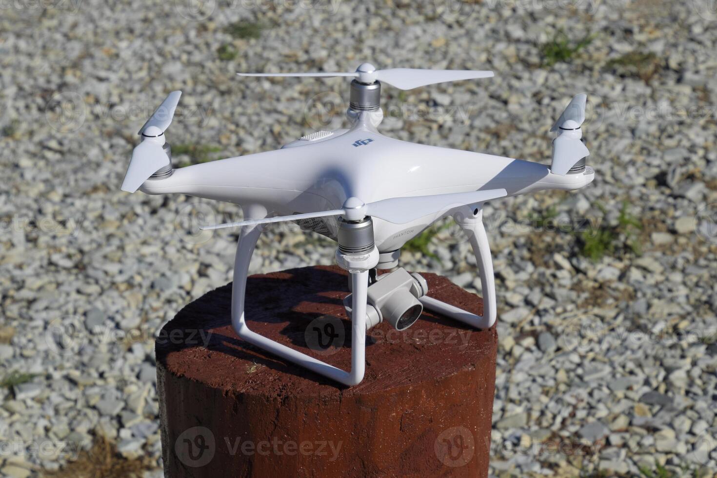 Quadrocopter DJI Phantom 4 on a wooden hemp. Preparing the drone for the flight. Dron is an innovative flying robot. photo