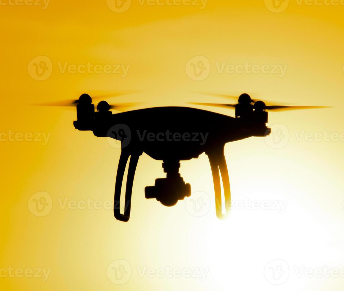 Quadrocopters silhouette against the background of the sunset photo