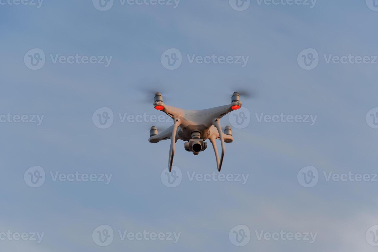 The drone, hovering in the sky. Flight quadrocopters photo