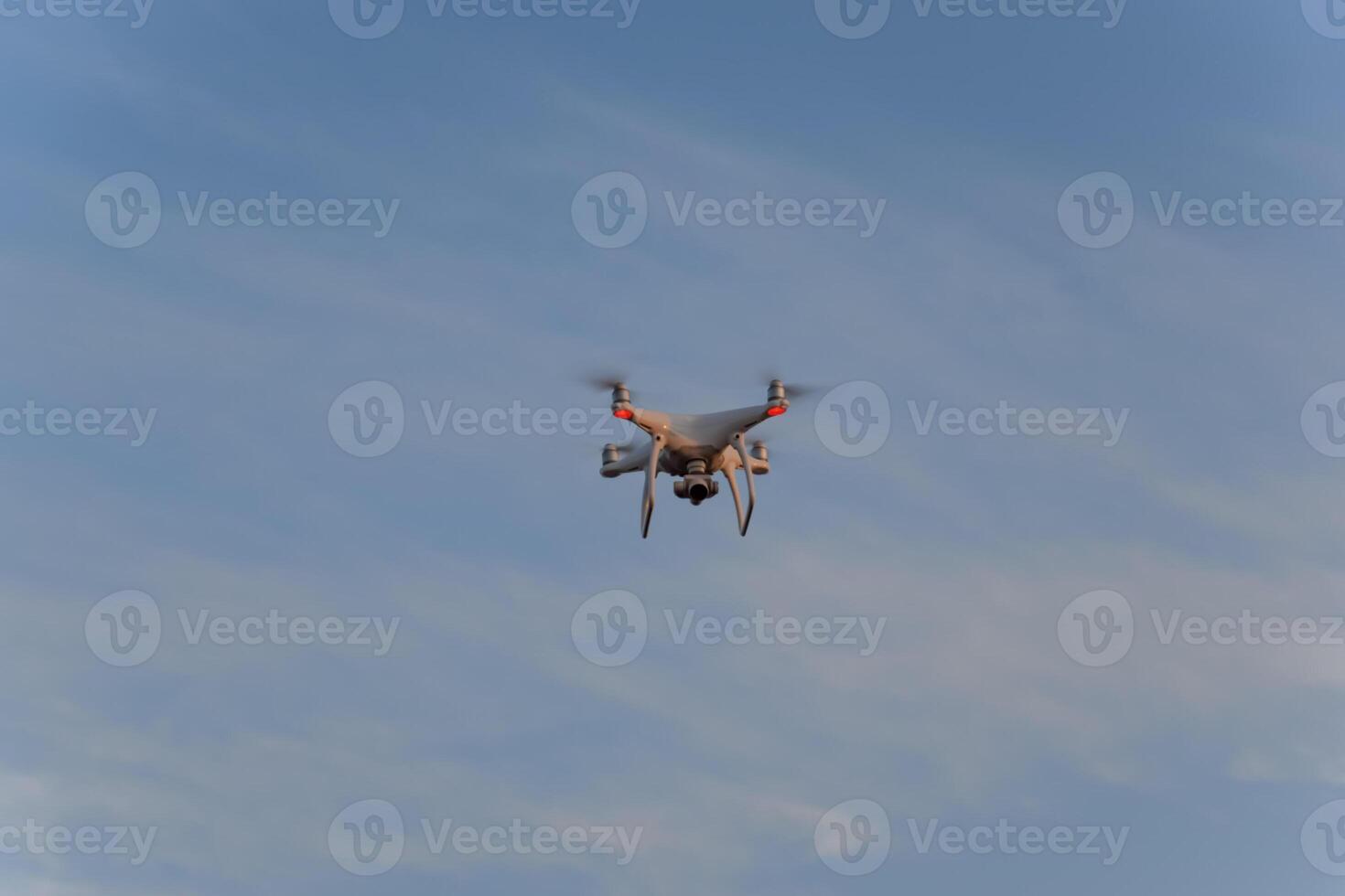 The drone, hovering in the sky. Flight quadrocopters photo