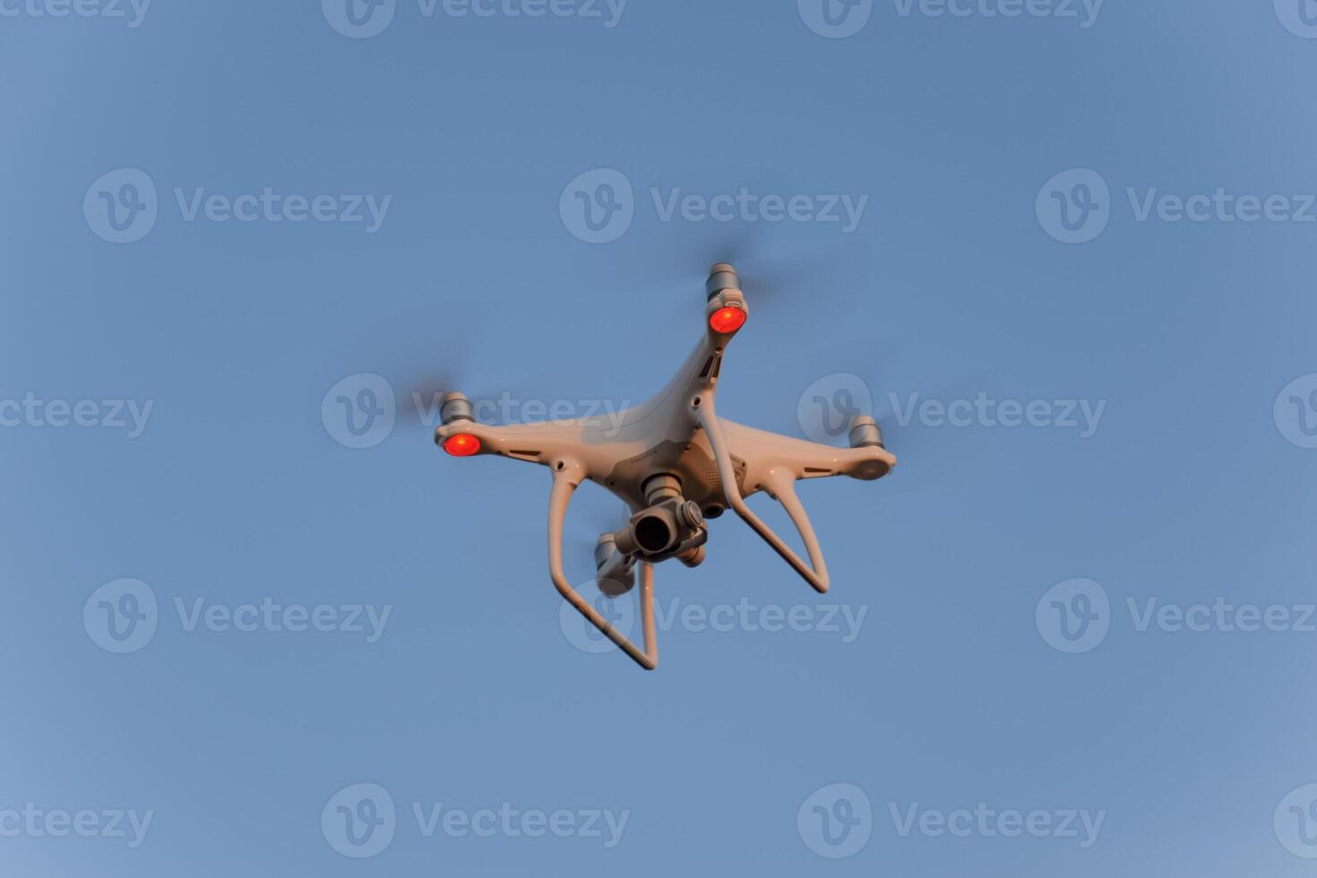 The drone, hovering in the sky. Flight quadrocopters photo