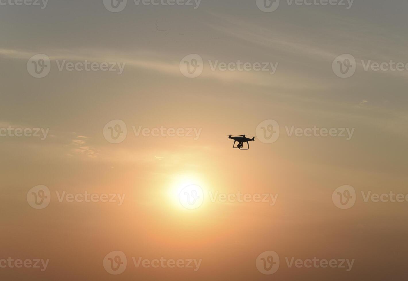 drone silhouette against the background of the sunset photo