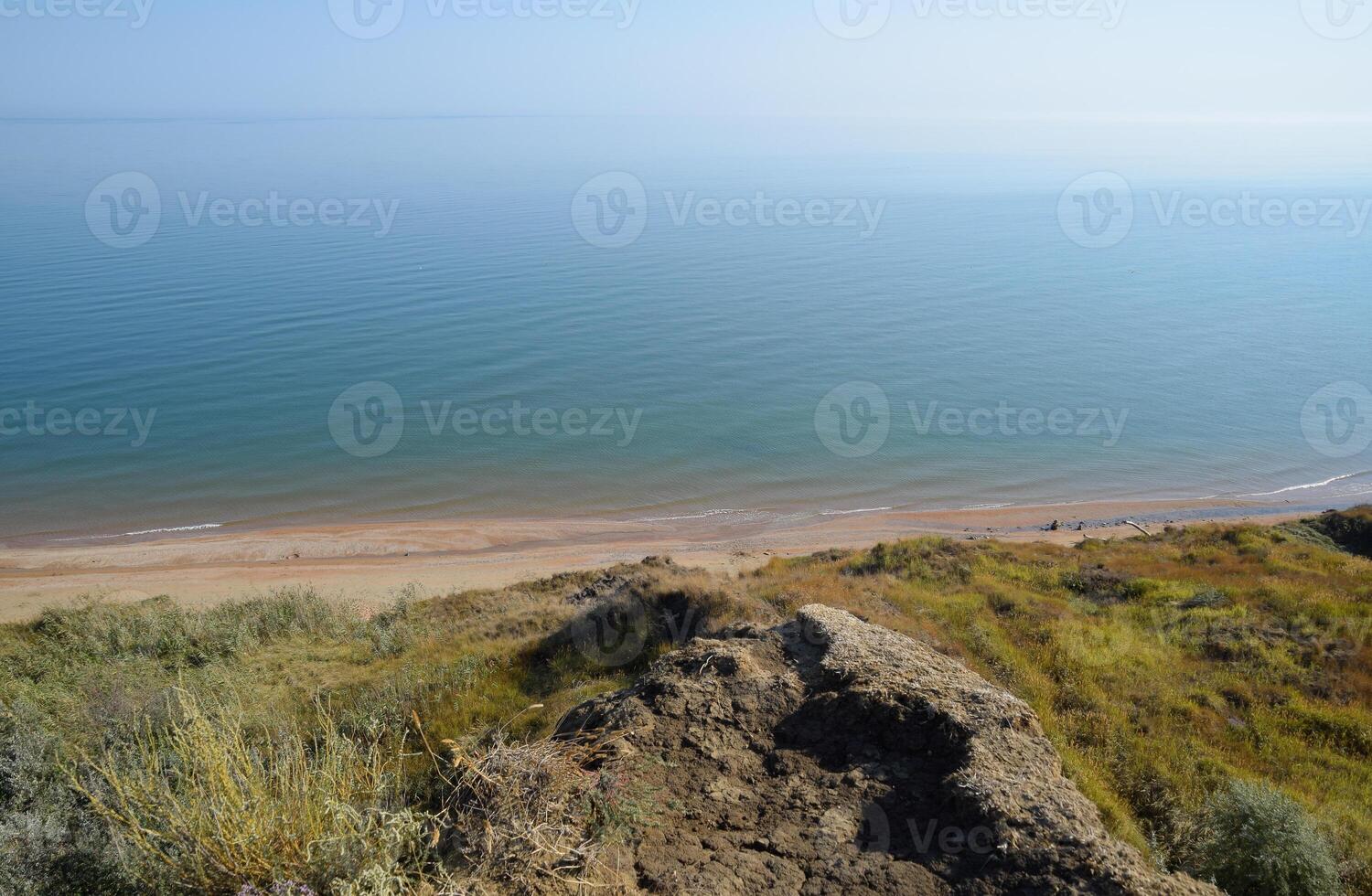 The hilly coast near the Sea of Azov. Clay rocks, a cliff on the shore photo