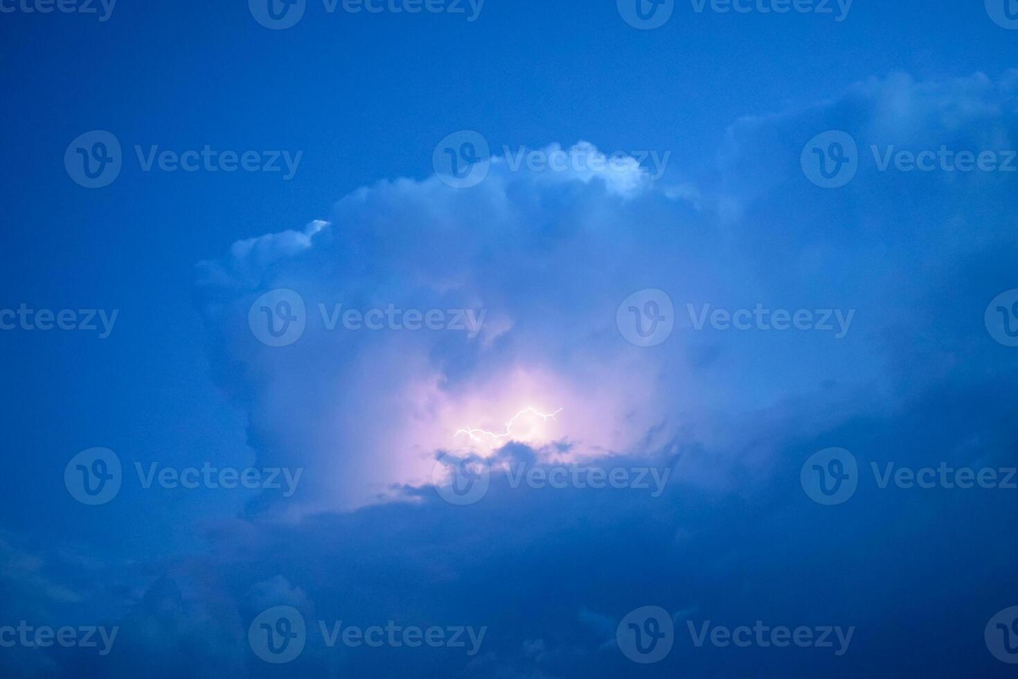 Lightnings in storm clouds. Peals of a thunder and the sparkling lightnings in clouds photo