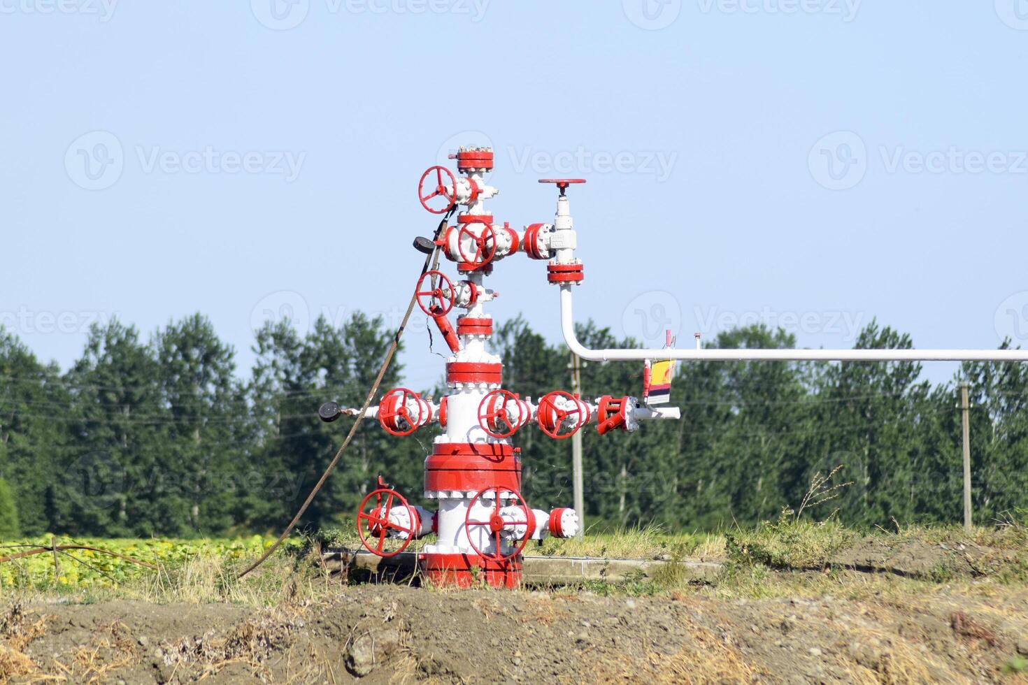 Well for oil and gas production. Oil well wellhead equipment. Oil production photo