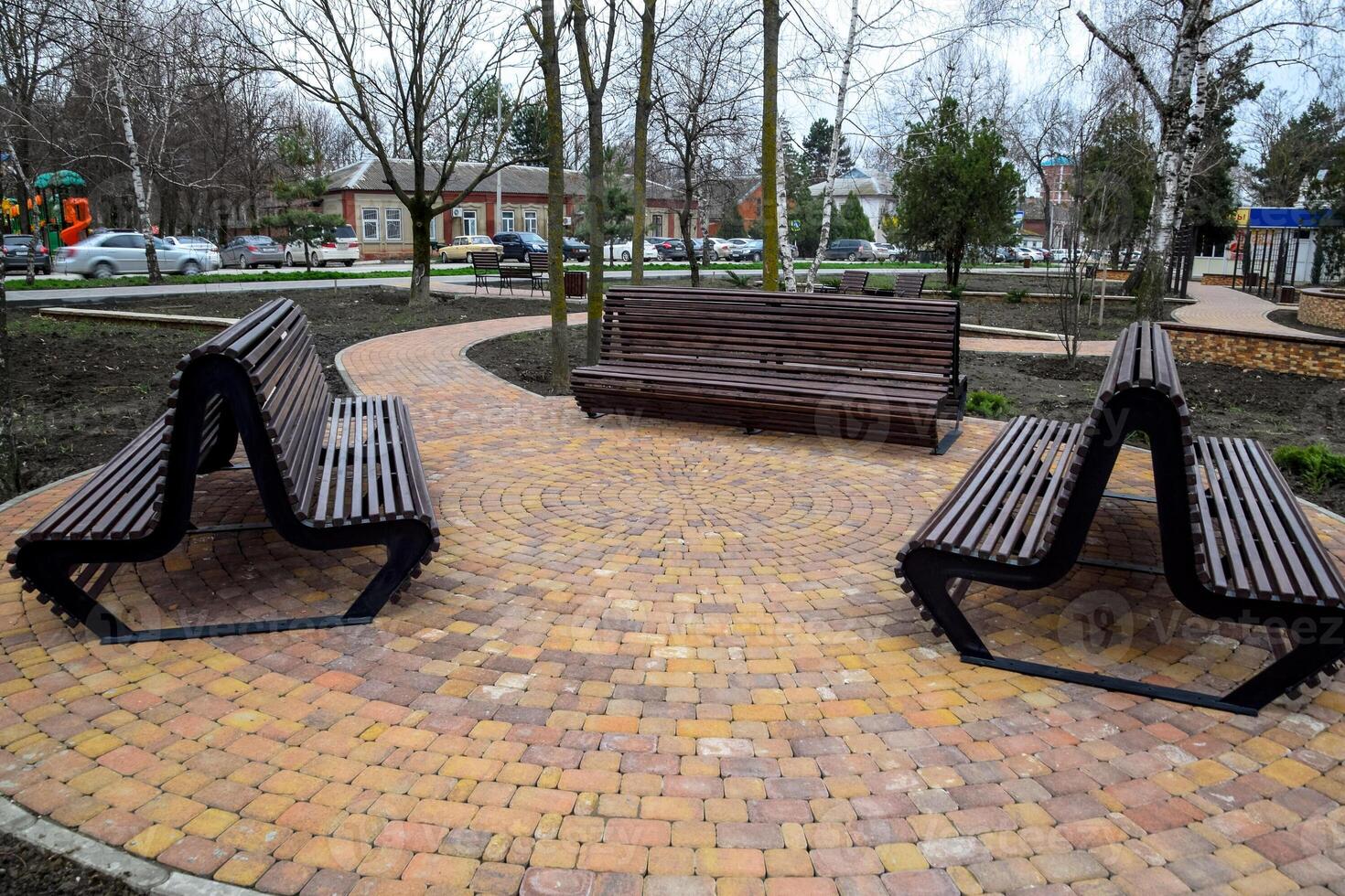 Benches in the park. Sidewalk tile in the park. Infrastructure of leisure in the park photo