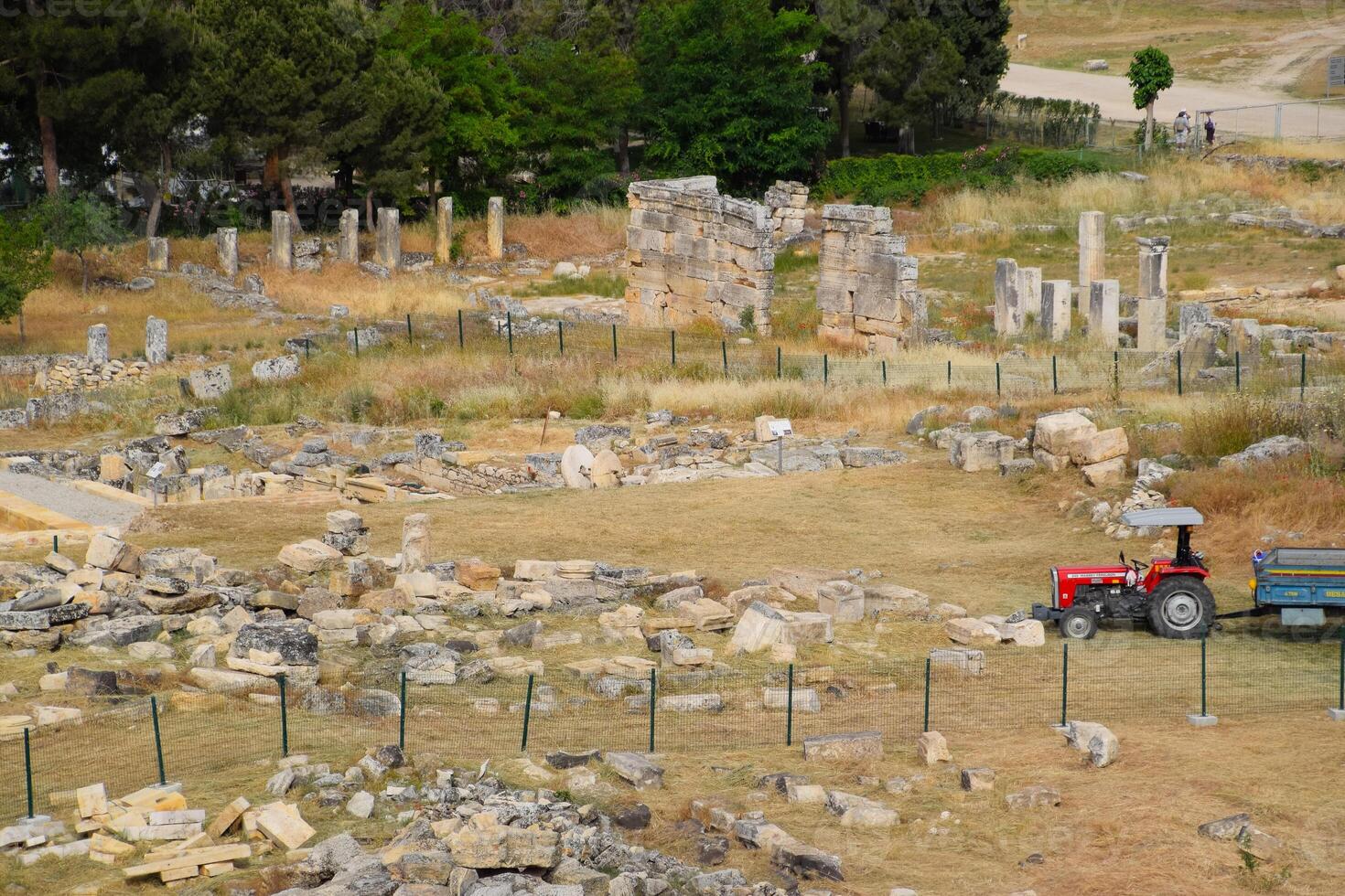 Top view of the excavation site in ruined ancient city of Hierapolis. The remains of destroyed buildings and columns. photo