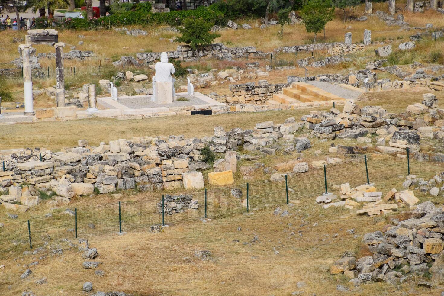 Top view of the excavation site in ruined ancient city of Hierapolis. The remains of destroyed buildings and columns. photo