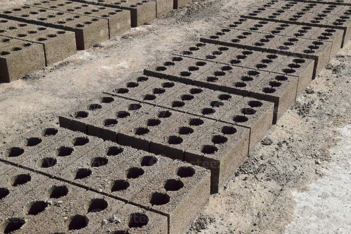 Cinder blocks lie on the ground and dried. on cinder block production plant. photo
