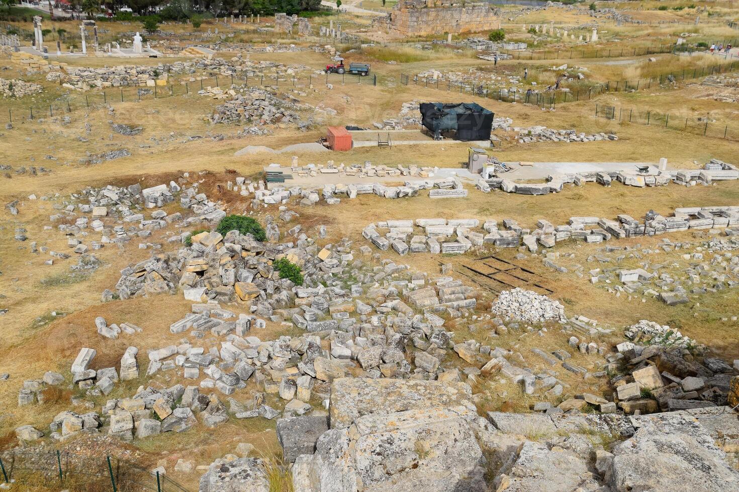 Top view of the excavation site in ruined ancient city of Hierapolis. The remains of destroyed buildings and columns. photo