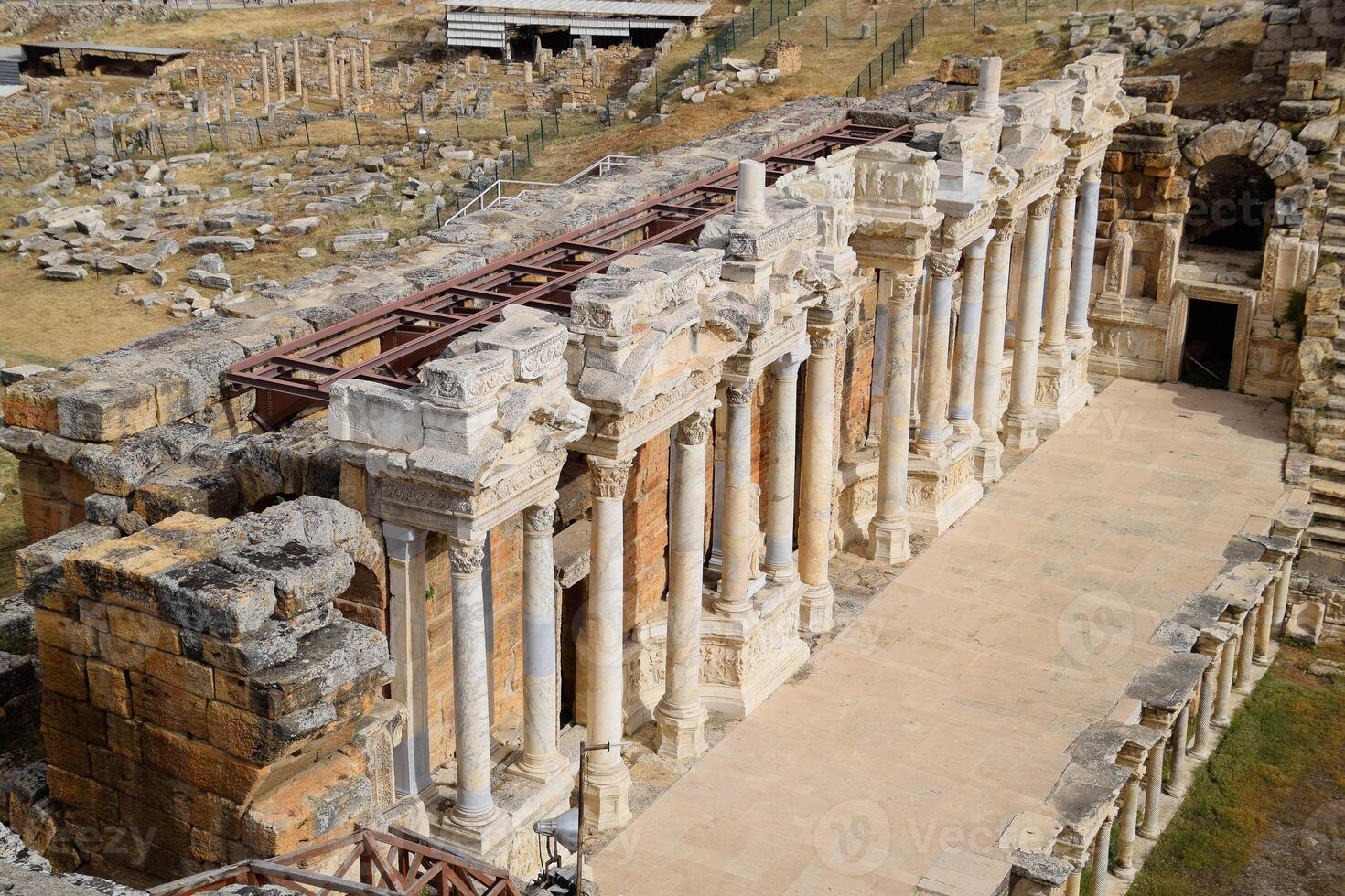 Columns on the stage of the amphitheater. Ancient antique amphitheater in city of Hierapolis in Turkey. photo