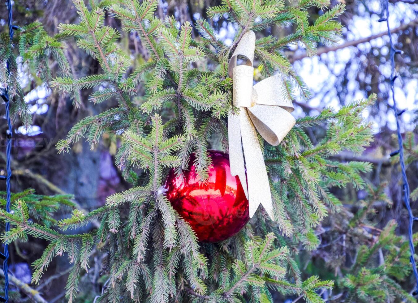 Decorations New Year tree. Tinsel and toys, balls and other decorations on the Christmas Christmas tree standing in the open air. photo