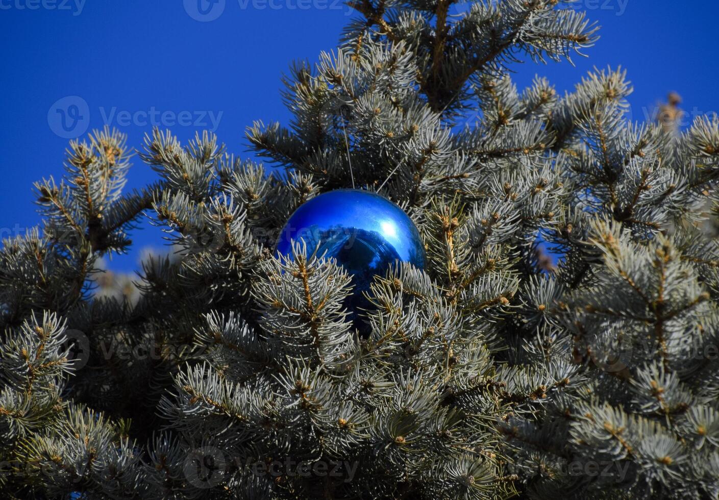 Decorations New Year tree. Tinsel and toys, balls and other decorations on the Christmas Christmas tree standing in the open air. photo