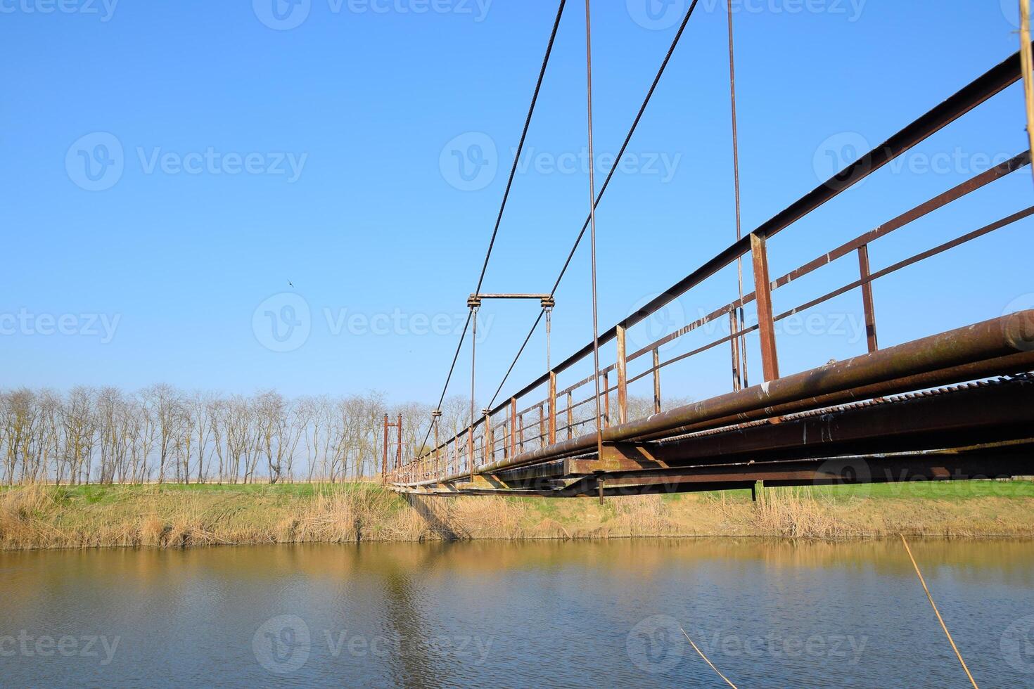 Steel bridge and gas pipeline through irrigation canal. photo