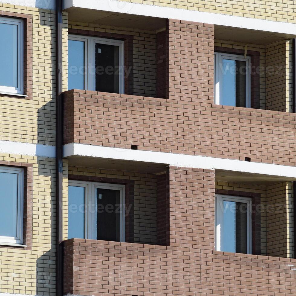 Balconies and windows of a multi-storey new house photo