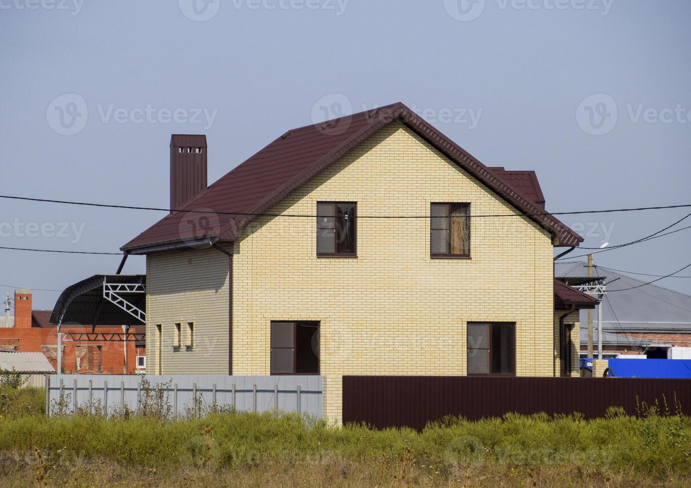 The house with plastic windows and a roof of corrugated sheet photo