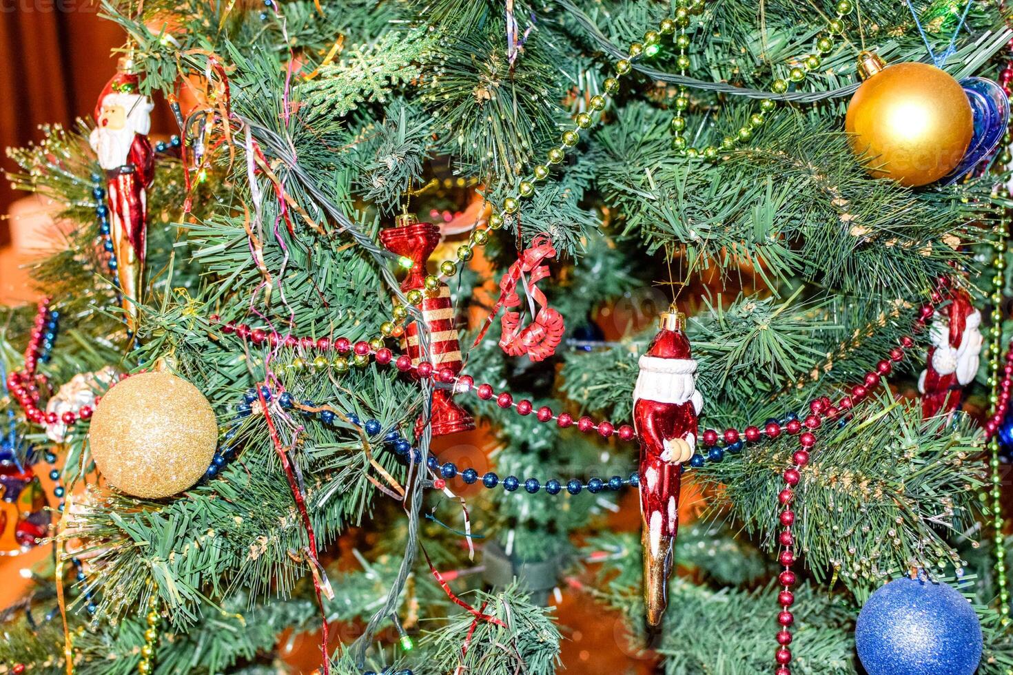 Decorations New Year tree. Tinsel and toys, balls and other decorations on the Christmas Christmas tree standing in the open air. photo