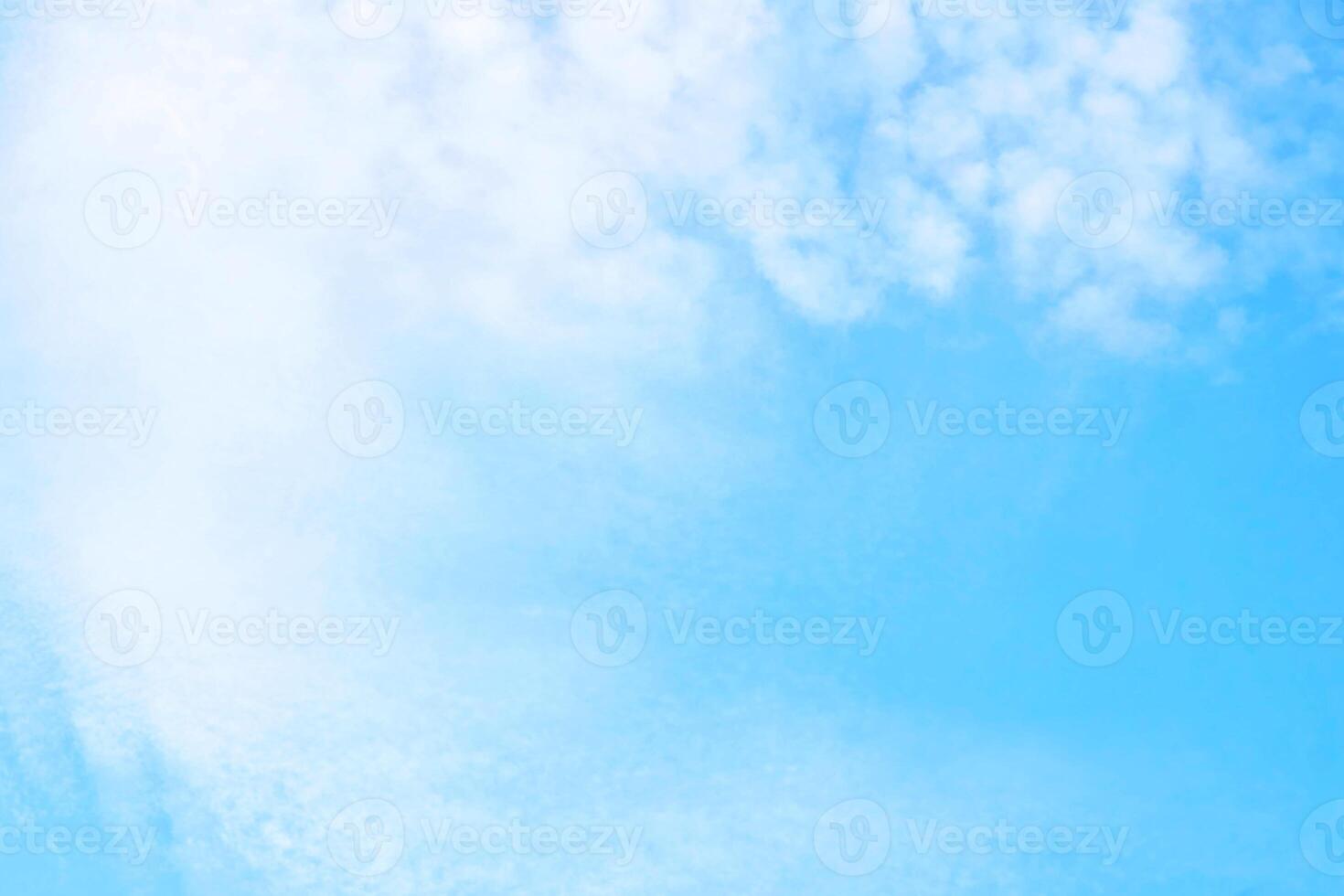 Light bright blue peaceful sky with white cirrus clouds photo