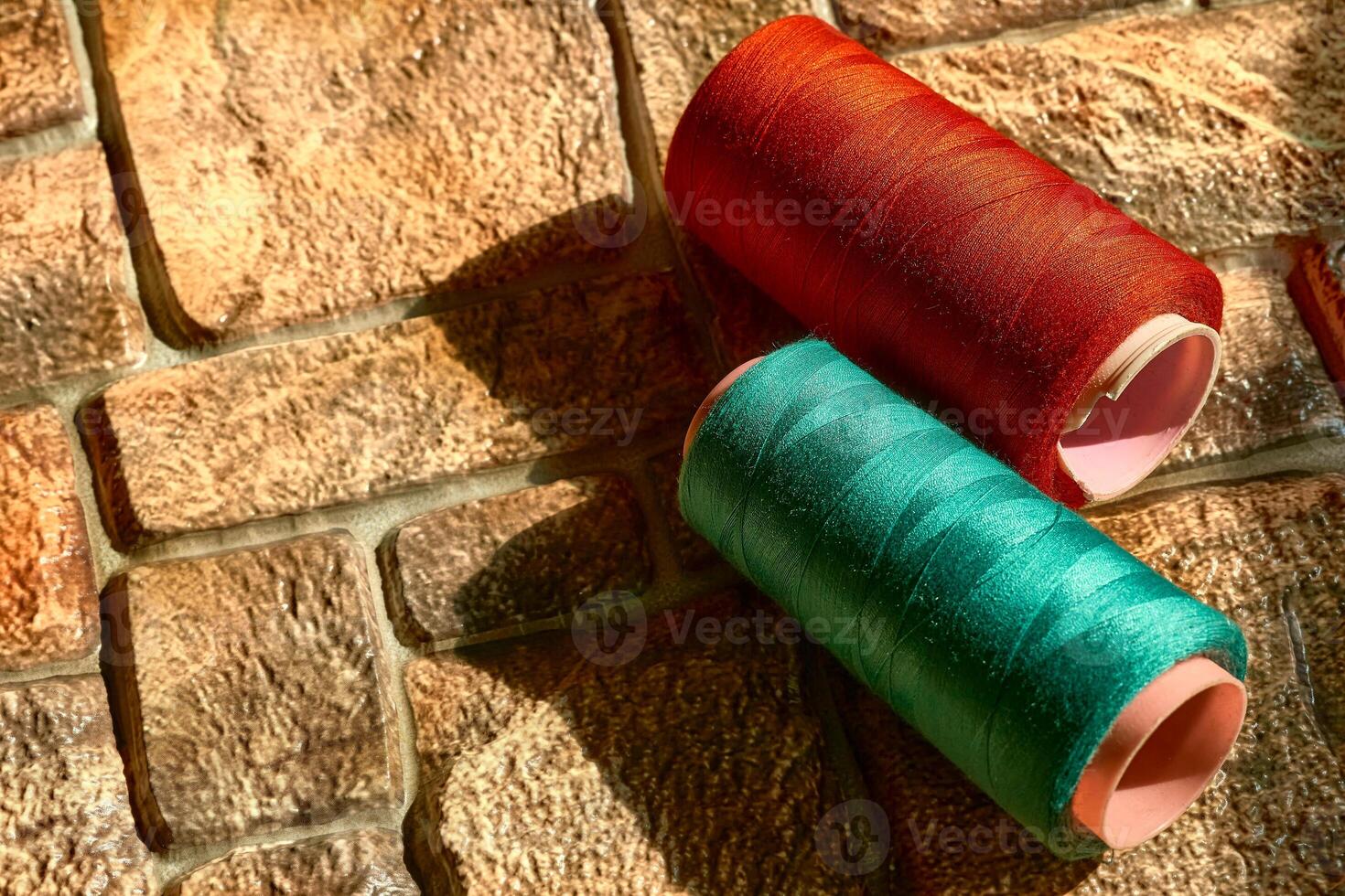 Two spools of sewing thread.Tailor. Emerald, red color photo