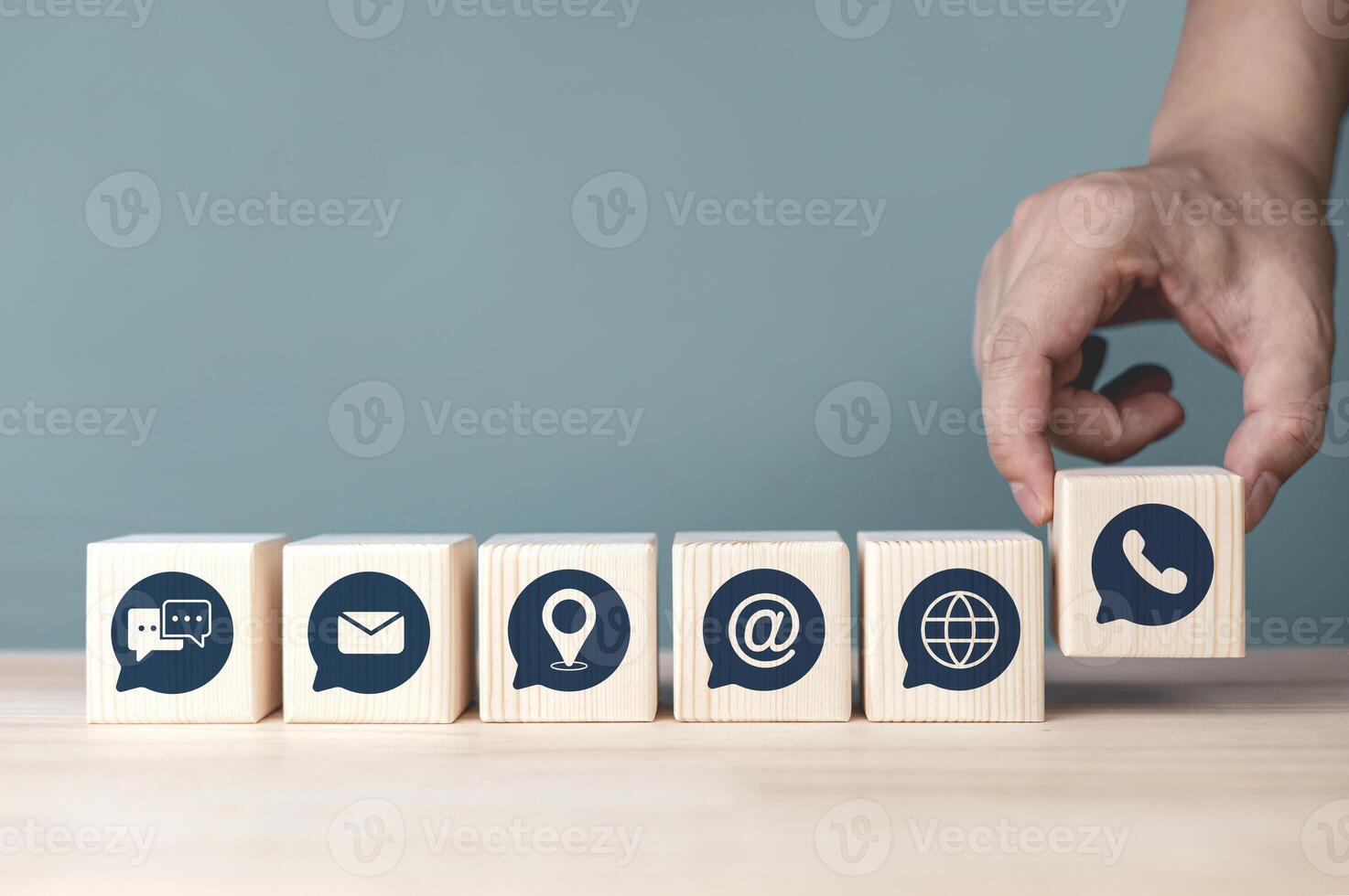 Contact us service hotline. Address, phone number, email and chat icons on wood block. concept of customer service department providing troubleshooting and answering inquiries. with copy space photo