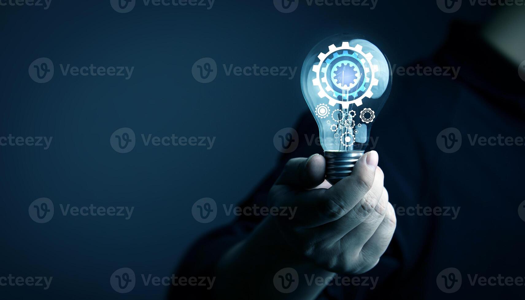 Creative thinking process. businessman holds a light bulb with gear icon. Meaning of excellent ideas, innovative design, and new inspiration in self-learning photo