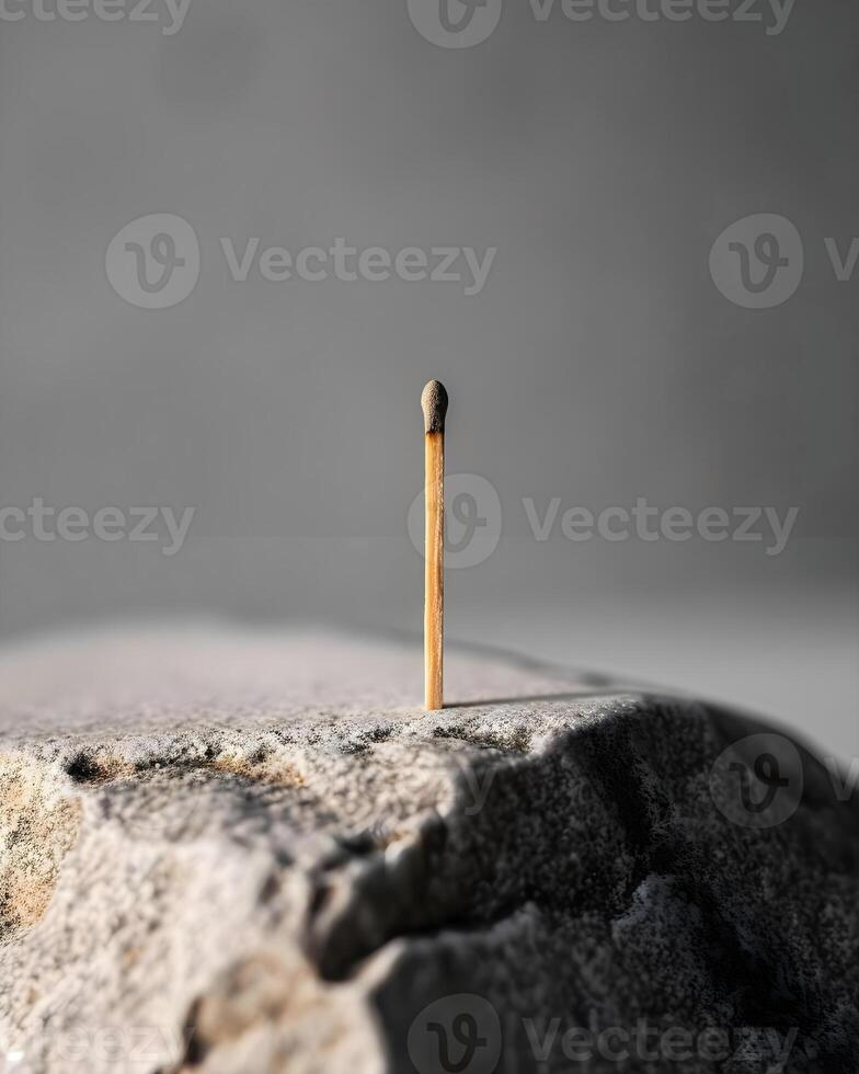 AI generated a single match stick sticking out of a rock photo