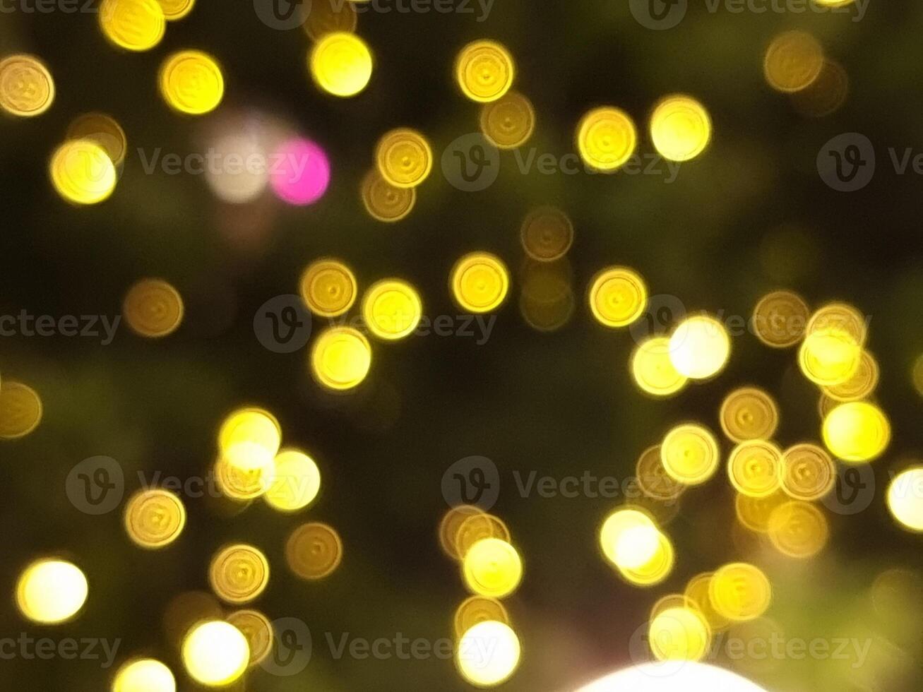 abstract bokeh blur light circle pink yellow and white glowing flare pattern black background photo
