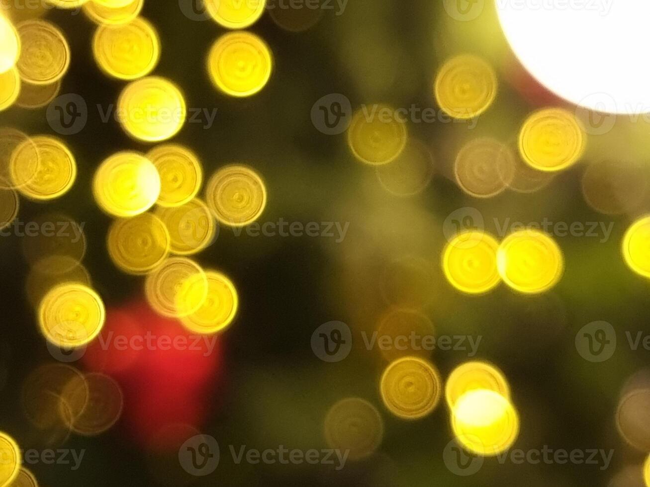 abstract christmas tree bokeh blur light circle red yellow and white glowing flare pattern black background photo