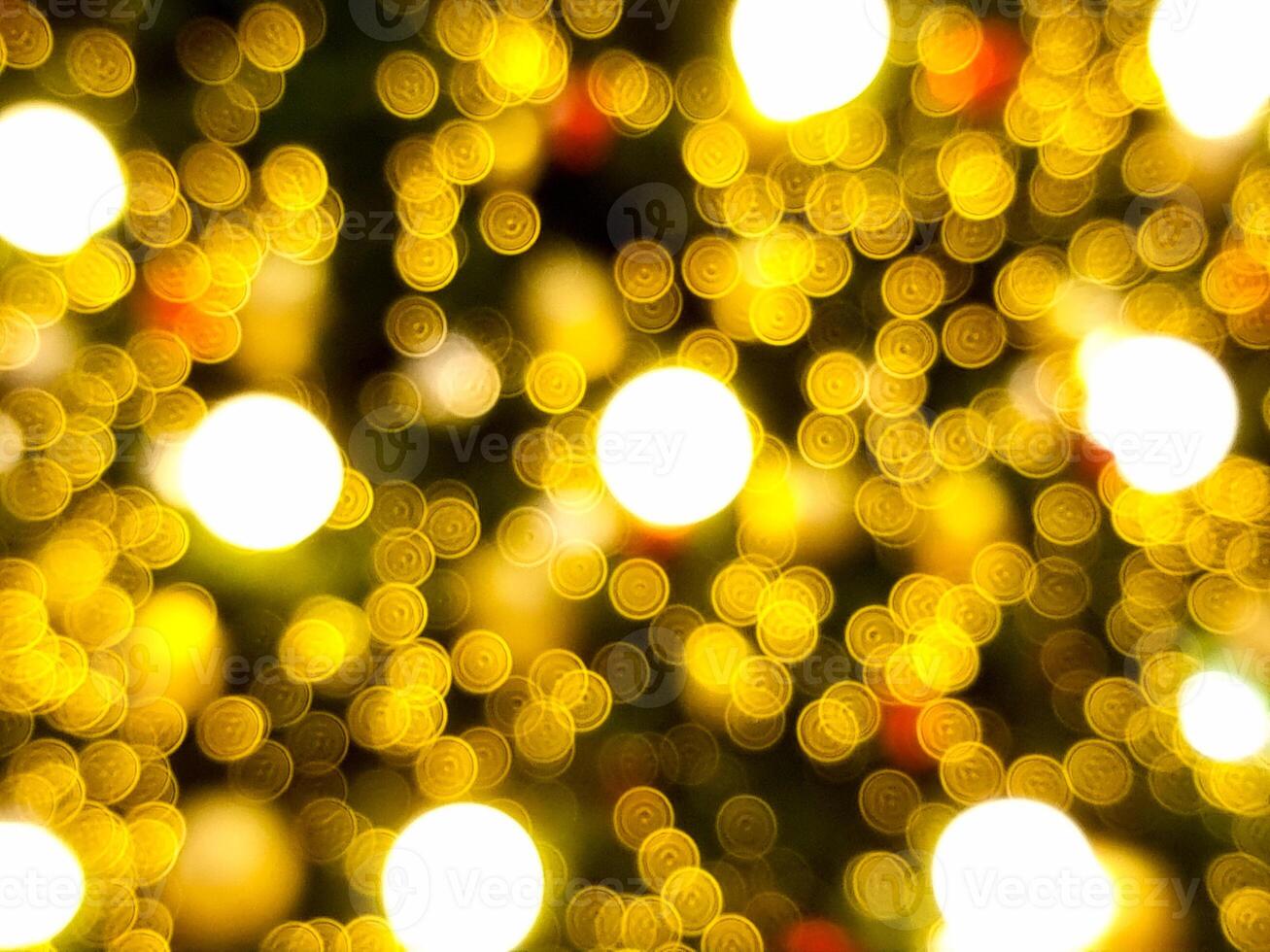 abstract bokeh blur light bubble circle red orange and white glowing flare pattern black background on christmas tree photo