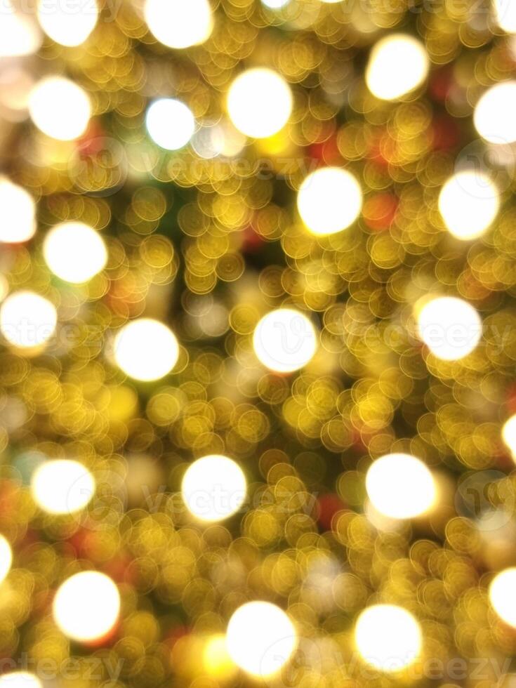vertical christmas tree abstract bokeh blur light circle red orange and white glowing flare pattern black background photo