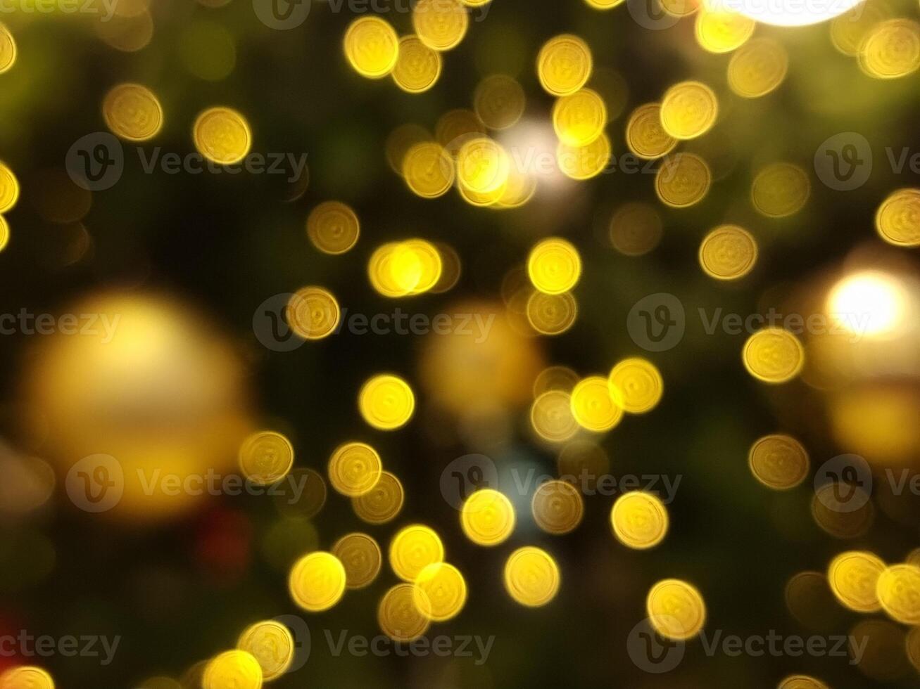 abstract bokeh blur light circle golden orange and yellow  christmas glowing flare pattern black background photo