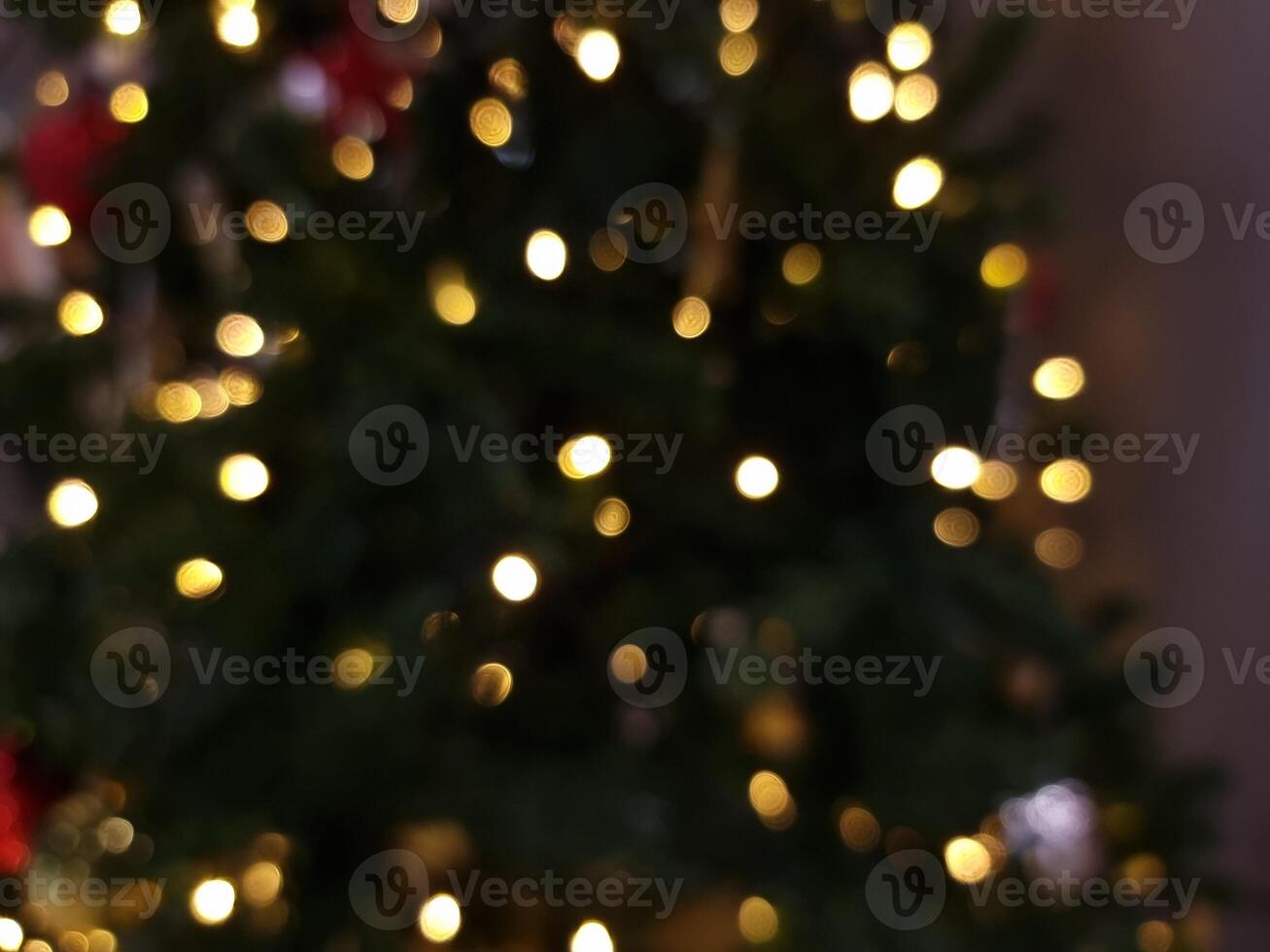 abstract bokeh christmas tree star blur light circle red orange and white glowing flare pattern black background photo