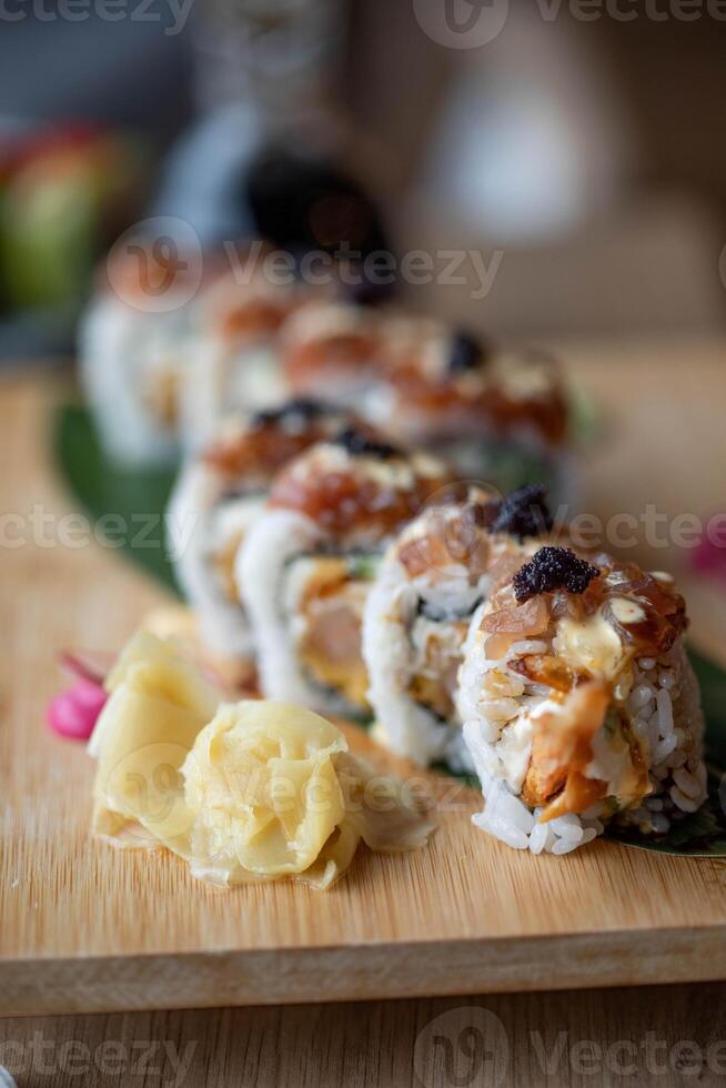 Sushi roll japanese food on a wooden plate, selective focus photo