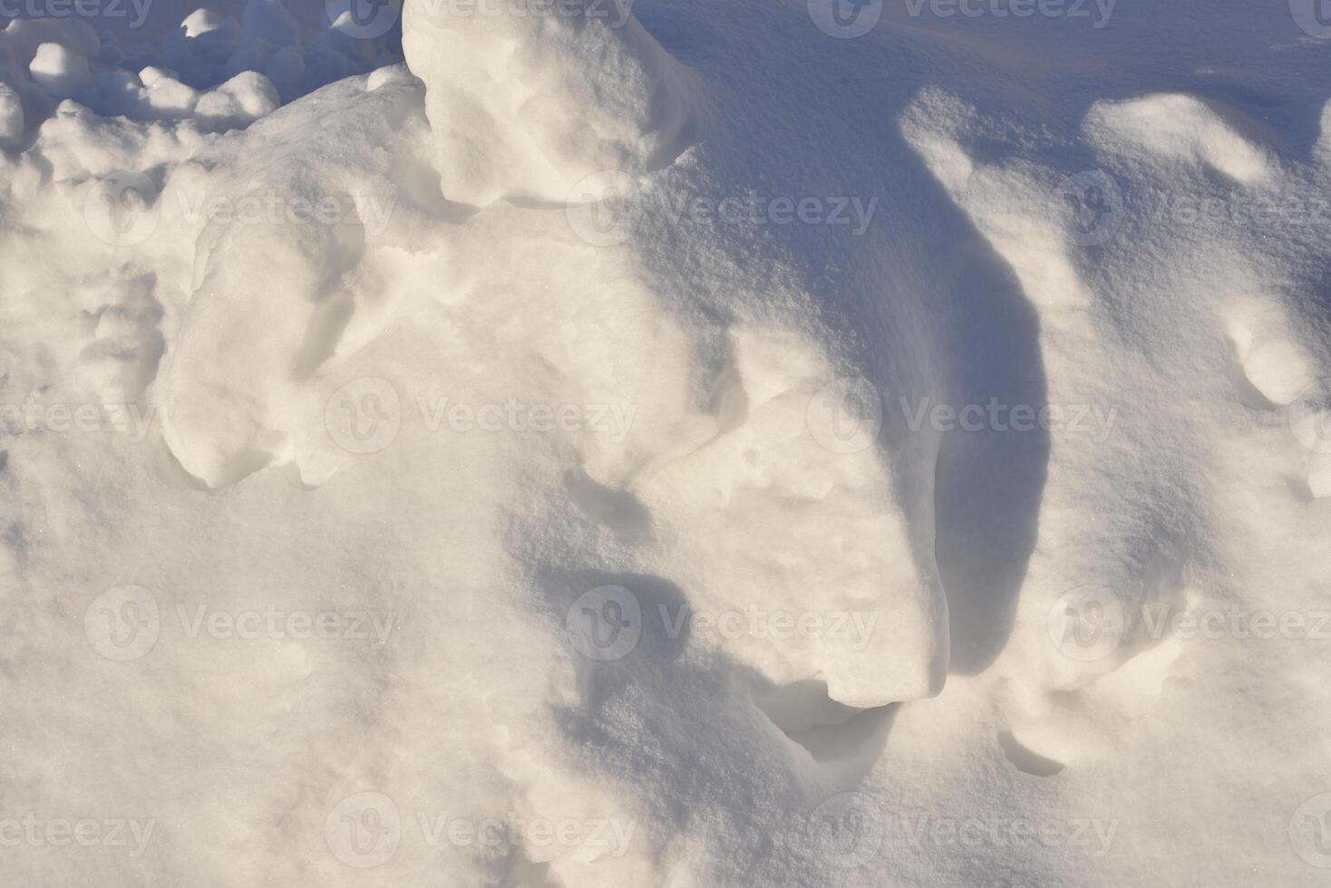 Lumps of snow in winter. Snow and light during the day. Snowdrifts. photo