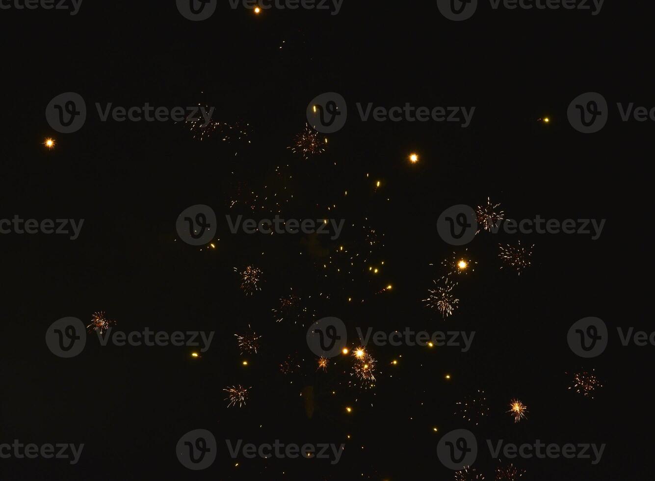 Fireworks shot at night. New Year's fireworks in the black sky. Christmas lights. photo